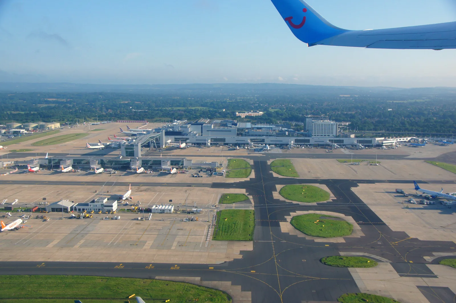 Aerial view of Gatwick Airport's North Terminal with aircraft on stand and the control tower in the background